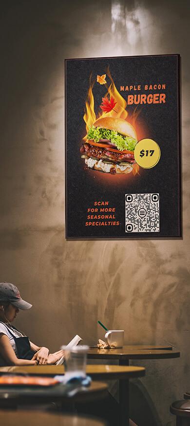 Poster on the restaurant wall displaying an image, text, and QR code for the menu