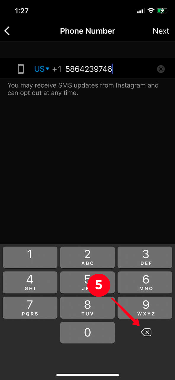 Tapping the delete icon on the keyboard on a mobile phone