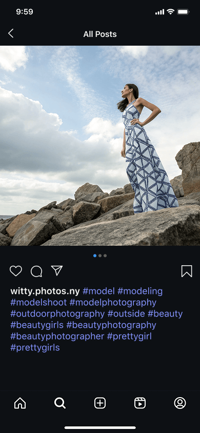 An Instagram post featuring an image of a young woman standing on a rocky beach and model photographer hashtags